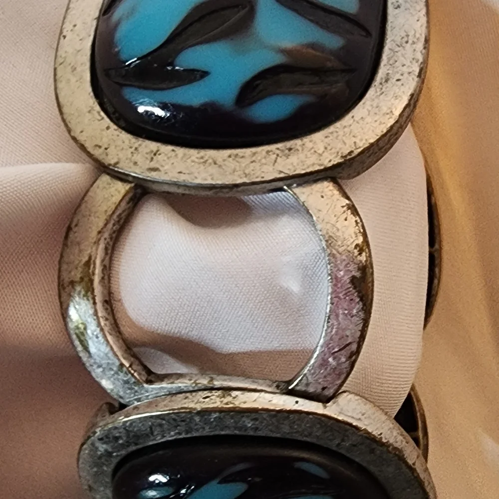 Cuff bracelet with a large, square, blue and black stone set in a Silver Tone